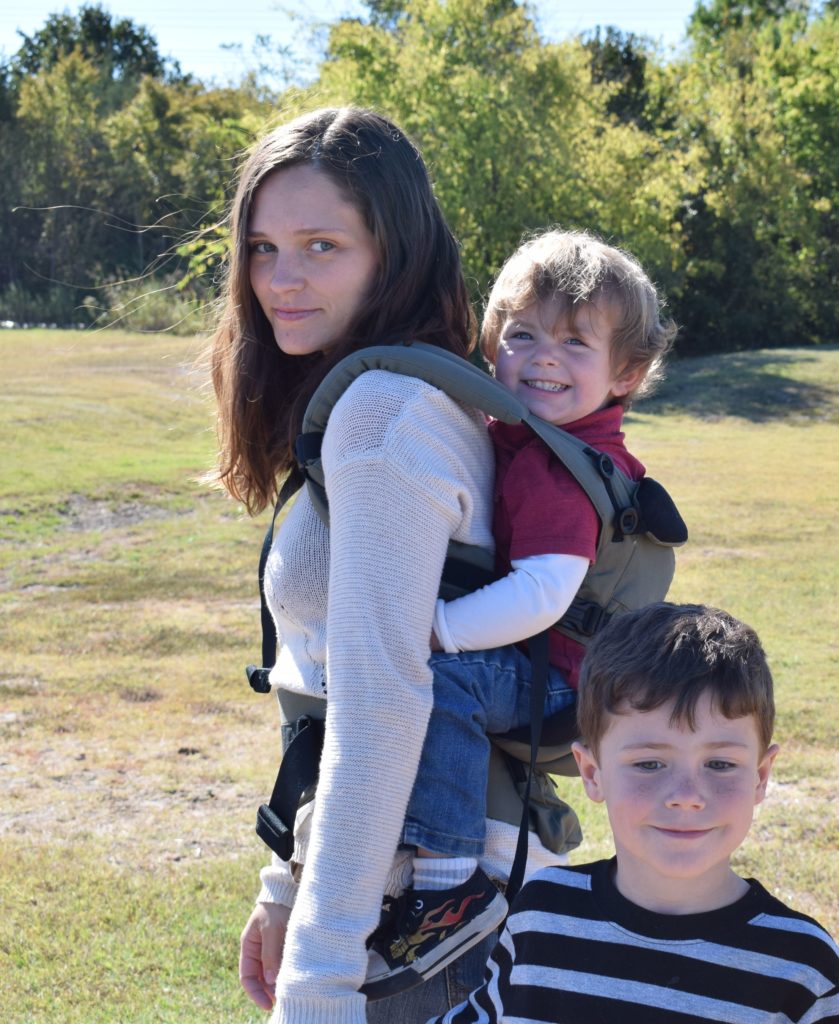 side view of toddler in a back carry in the ergobaby all-in-one carrier