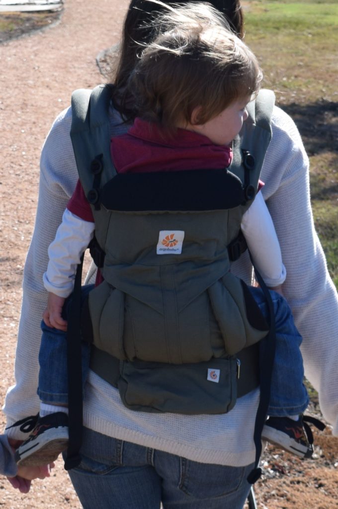 back view of toddler in a back carry in the ergobaby all-in-one carrier