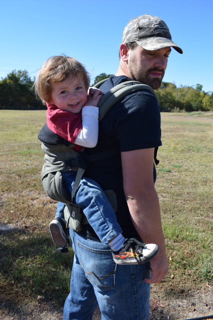 toddler in a back carry Omni 360 Baby Carrier on dad