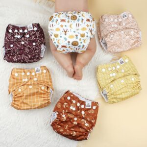 A set of 6 gender neutral cloth diapers with assorted cute patterns.